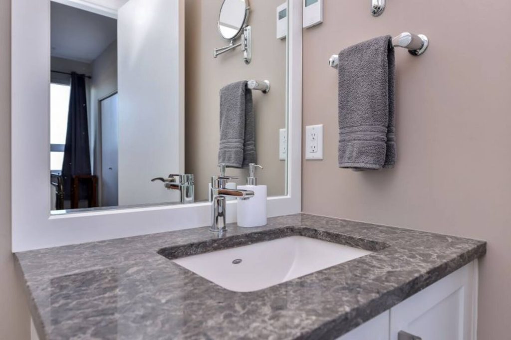 Master Ensuite with granite counter, vanity mirror, medicine cabinet & storage.