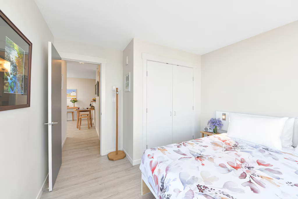 Full size double door clothes closet with iron, ironing board, shelving, etc....