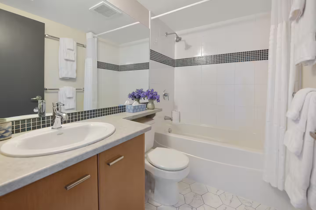 Full size bathroom with combination tub / shower, storage under sink w hairdryer